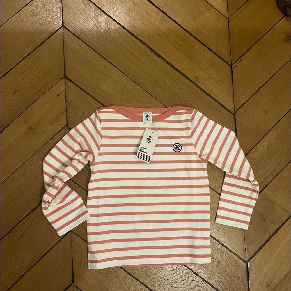 Pink striped sweater.